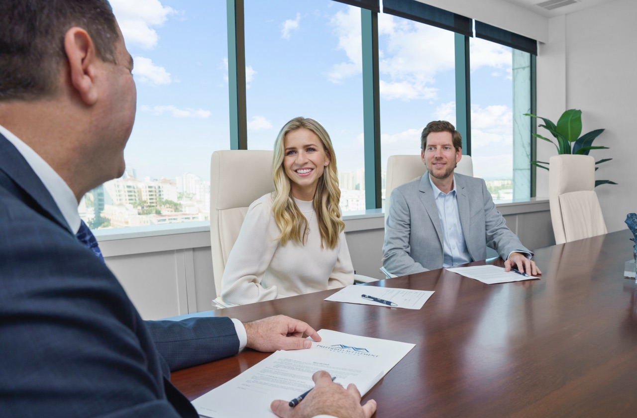 Photo of clients speaking with Title Attorney